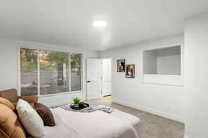 Bedroom featuring light carpet