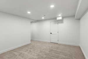 Basement with light colored carpet