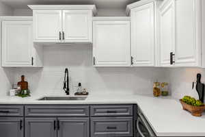 Kitchen with gray cabinetry and white cabinetry