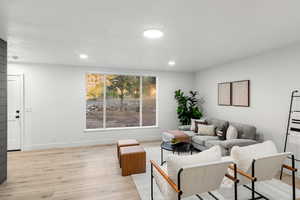 Living room with light hardwood / wood-style flooring