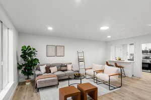 Living room featuring light hardwood / wood-style floors and plenty of natural light