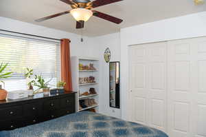 Bedroom with ceiling fan and one of two closets in the room