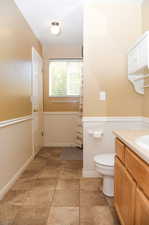 Bathroom with tile patterned floors, vanity, and toilet