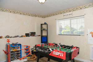 Game room featuring a textured ceiling and new LVP flooring