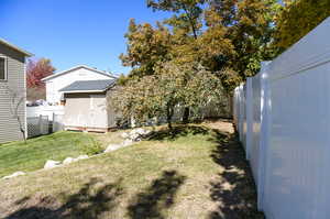 View of yard with a storage unit