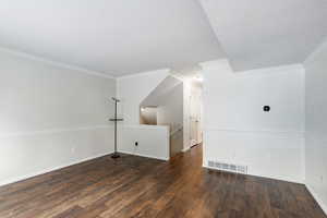 Bonus room with dark wood-type flooring