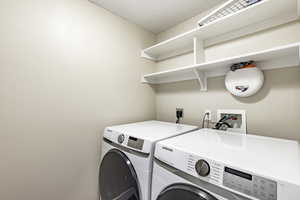 Washroom featuring separate washer and dryer and a textured ceiling