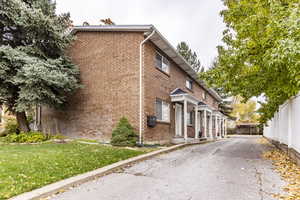 View of side of property featuring a yard