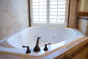 Bathroom featuring a tub to relax in