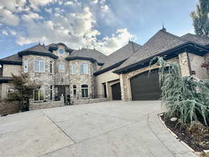 French country inspired facade with a garage