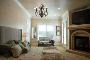 Bedroom featuring ornamental molding, carpet flooring, and a chandelier