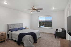 Carpeted bedroom with ceiling fan