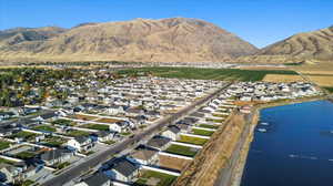 Birds eye view of property with a water and mountain view