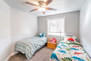 Bedroom with light carpet and ceiling fan