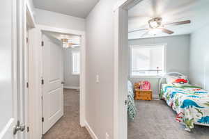 Carpeted bedroom with ceiling fan