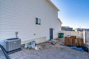 Back of house with central air condition unit