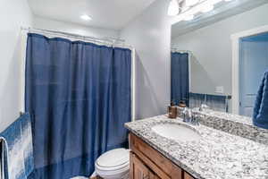 Bathroom featuring vanity and toilet