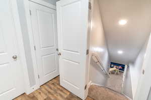 Stairs featuring hardwood / wood-style floors