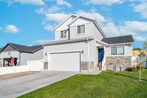 View of front of home featuring a garage and a front yard