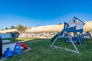 View of play area with a lawn