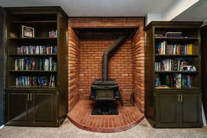 Carpeted living room with a wood stove