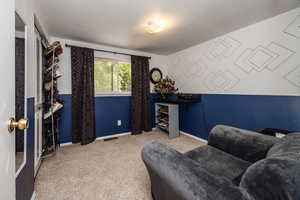 Interior space with light carpet and a textured ceiling