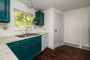 Kitchen featuring decorative backsplash, dishwasher, sink, and dark hardwood / wood-style flooring