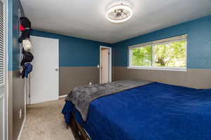 Bedroom featuring a textured ceiling and light colored carpet