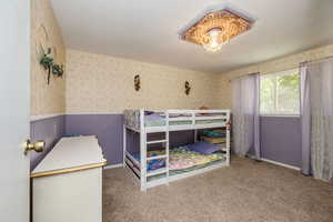 Bedroom with carpet floors and a textured ceiling