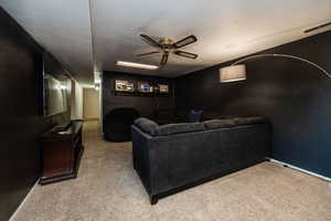 Living room with light carpet and ceiling fan