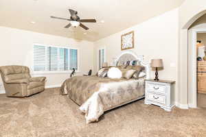 Carpeted bedroom with ceiling fan