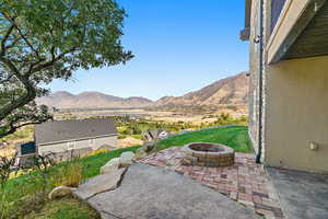 View of patio / terrace with a mountain view and an outdoor fire pit