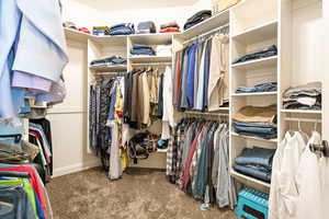 Walk in closet with carpet flooring