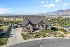 View of front of property with a mountain view and a front yard