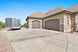 View of side of home featuring a garage