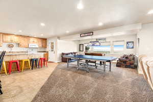 Game room with a textured ceiling and light carpet