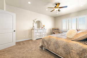 Bedroom featuring ceiling fan and carpet floors