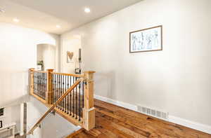 Stairs with hardwood / wood-style floors