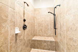 Bathroom featuring a tile shower