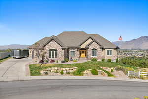 French provincial home featuring a mountain view and a front yard