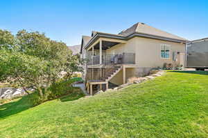 Rear view of property with a yard