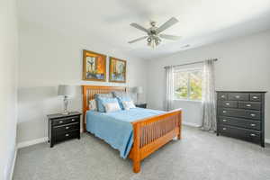 Bedroom with light carpet and ceiling fan