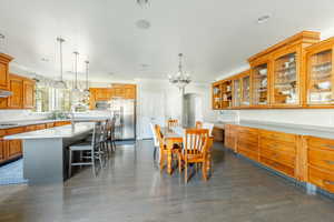 Dining room featuring ornamental molding, dark hardwood / wood-style flooring, a chandelier, and sink