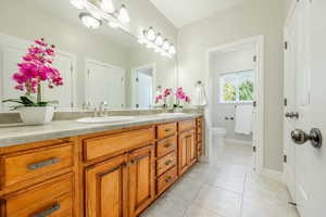 Bathroom featuring tile patterned flooring, vanity, and toilet