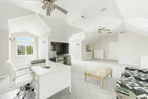 Carpeted living room with vaulted ceiling and ceiling fan