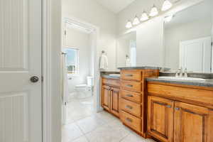 Bathroom with tile patterned floors, vanity, and toilet