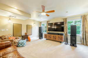 Living room featuring light carpet, a wealth of natural light, and ceiling fan