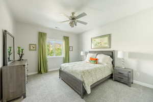 Bedroom with light carpet and ceiling fan