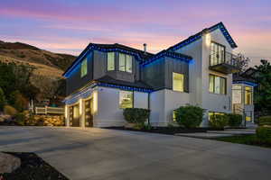 View of front of house with a balcony, a mountain view, and a garage