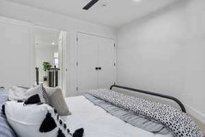 Bedroom with ceiling fan and a closet